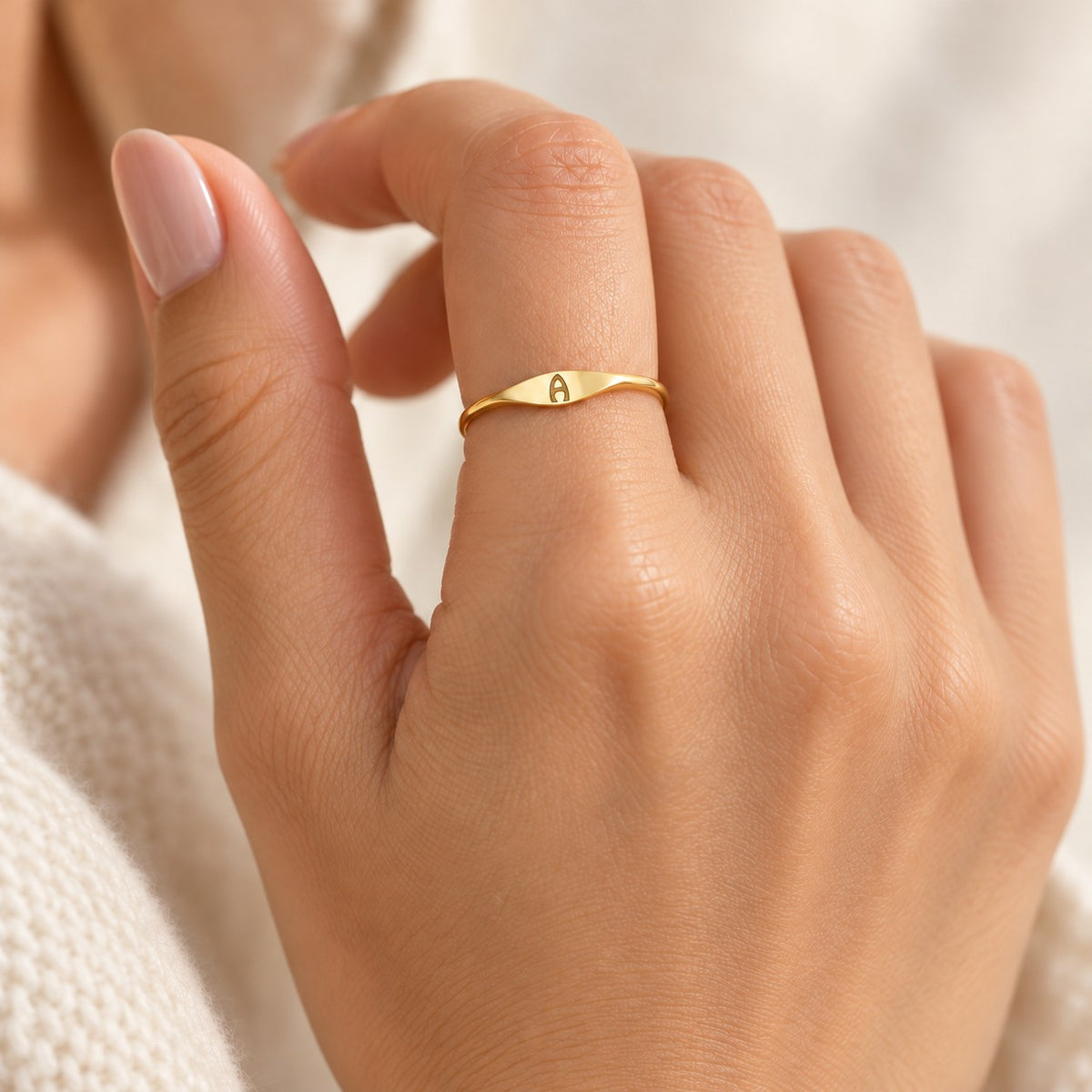 Velmora initial letter ring worn on the index finger