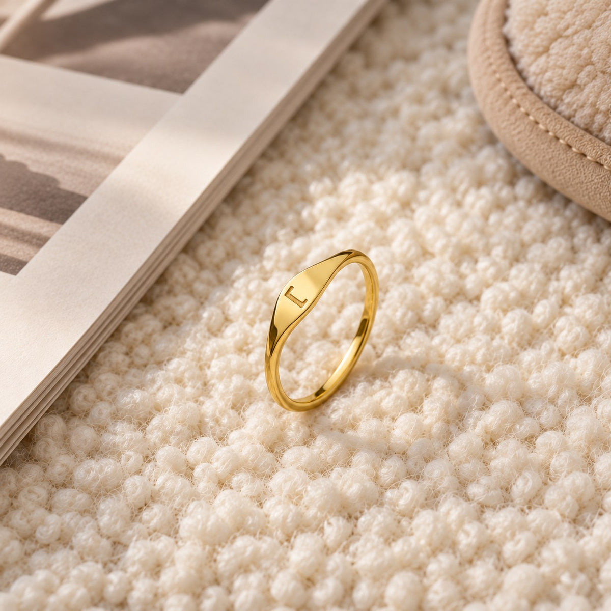 Velmora initial letter ring on cream fabric